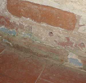 Quarry tile floor meets brick wall - needs 'tanking' below the damp proof course
